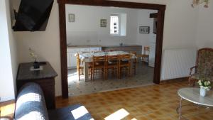 a kitchen and dining room with a table and chairs at Maison 50m de la mer parking privé in Cancale +17 photos