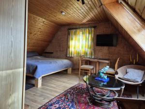a bedroom with a bed and a table in a room at Spitzbodennest am Wald in Osnabrück