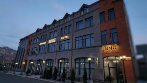 a building on a street with a bing building at BMG Hotel by Grigoryans Group in Goris