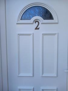 a door with a number two on it at Hôtel du petit verger in Saint-Germain-des-Prés