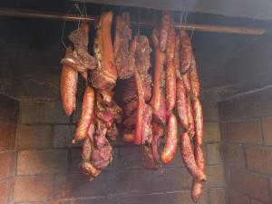 a bunch of carrots and meat hanging from a brick wall at Chambres et Table d'hôte Les Hortensias in La Plaine des Cafres +57 photos