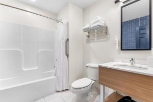 a bathroom with a toilet and a sink and a shower at Spark by Hilton Essex Junction Burlington in Essex Junction