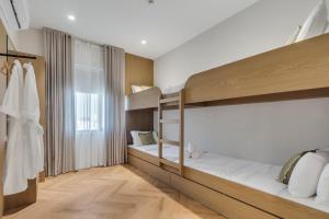 a room with two bunk beds and a window at The Hideout, Khorfakkan in Khor Fakkan