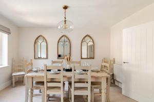ein Esszimmer mit Tisch und Stühlen in der Unterkunft Spacious 4-BR House in Oxfordshire with Free Parking and Wi-Fi in Long Hanborough