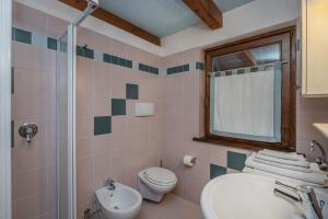 ein Badezimmer mit Waschbecken und Toilette und einem Fenster in der Unterkunft Romantic Hideaway with Mountain View and Hiking Trails in Terzels