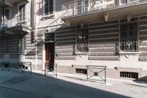 a building with black chairs in front of a building at Clair de Lune in Asti
