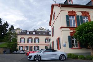 a white car parked in front of a building at Romantik Hotel Villa Sayn in Bendorf