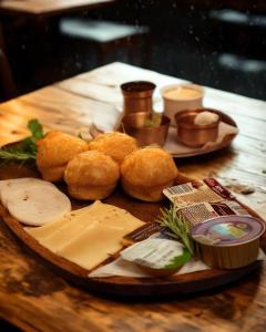 a plate of cheese and bread on a wooden table at Motel Ječmište in Tuzla +53 photos