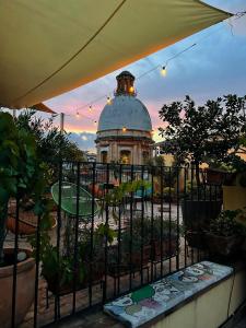 une vue d'un bâtiment derrière une clôture avec des plantes dans l'établissement Magma Home - Rooms & Roof, à Naples