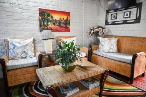 a living room with two couches and a table at Matts Rest bnb & Selfcatering in Vosburg