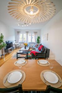 a dining room and living room with a table and chairs at Large Central 2BR - Scandinavian Design - Balcony in Gothenburg