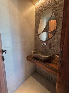 a bathroom with a sink and a mirror at Rastoni Suites Xylokastro 1 in Melission +15 photos