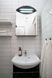 a bathroom with a sink and a mirror and towels at Large Central 2BR - Scandinavian Design - Balcony in Gothenburg +61 photos