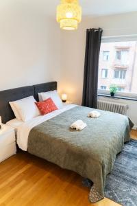 a bedroom with a large bed with two towels on it at Large Central 2BR - Scandinavian Design - Balcony in Gothenburg