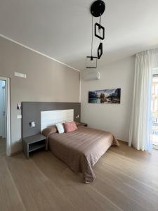 a bedroom with a large bed and a chandelier at Dreams29 in Cosenza