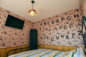 a bedroom with a bed and a wall covered in flowers at cinéma immersif et chambres à thème dans le centre in Saint-Omer +23 photos