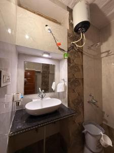 ein Badezimmer mit Waschbecken und Spiegel in der Unterkunft Hotel Temple View in Jaisalmer