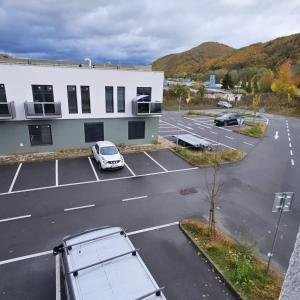 an aerial view of a parking lot in front of a building at Hron River View Apartment in Banská Bystrica +21 photos