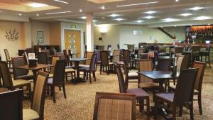 a dining room with tables and chairs and a bar at Jasmine Corner - entertainment passes included - message for longer stays in Ringwood