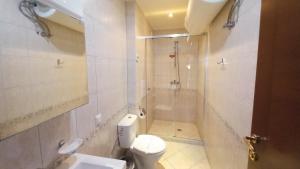 a bathroom with a shower and a toilet and a sink at 5-Star Beachfront Luxury Apartments in Sveti Vlas +32 photos
