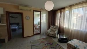 a living room with a couch and a chair and a table at 5-Star Beachfront Luxury Apartments in Sveti Vlas