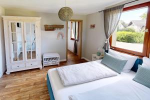 a bedroom with two beds and a large window at Sommerhaus am Nationalpark Eifel mit Sauna in Monschau