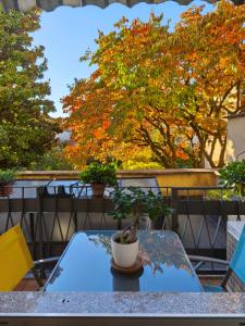 a table with a potted plant on it on a balcony at Ca' De Amicis Rho Centro - posto auto privato in Rho