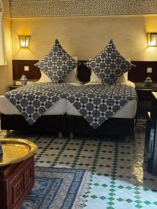 a bedroom with a large bed with pillows on it at Riad Dar Laura in Fès