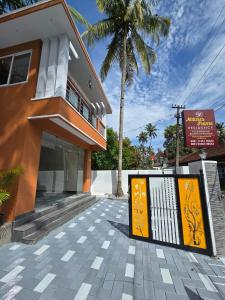 a building with a sign in front of it at Nature's Frame Residency in Varkala