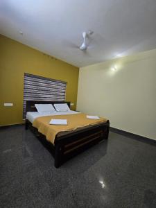 a bedroom with a large bed in a room at Nature's Frame Residency in Varkala +5 photos