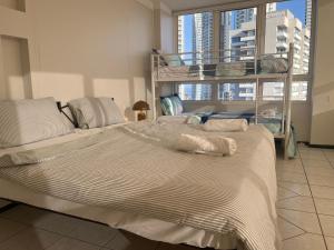 a bedroom with two bunk beds and a large window at Luxury Views King Ensuite Pool Theatre Mini Golf in Gold Coast +39 photos