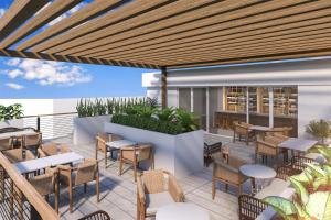 an outdoor patio with tables and chairs and a restaurant at Hilton Miami Beach in Miami Beach
