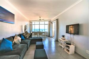 a living room with a couch and a table at Sea Lodge 61 in Durban