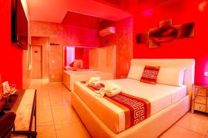 a bedroom with a bed with a red wall at Bed Cinecitta’ in Rome