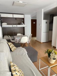 a living room with a couch and a bunk bed at Apartamento Plaza in Villajoyosa