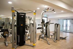 a gym with several treadmills and cardio machines at Mandali Hotel in Protaras