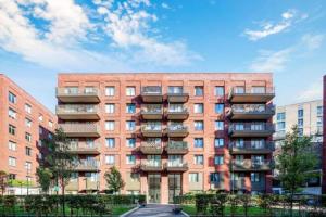a large brick building with balconies on the side of it at HomeStay near London City Airport, London Excel & O2 in North Woolwich