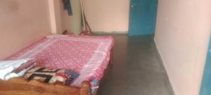 a bedroom with a pink bed in a room at Hotel O Chandrapur Gadchandur formerly Hotel Relax in Chāndur
