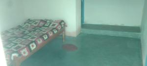 a bedroom with a bed in a room at Hotel O Chandrapur Gadchandur formerly Hotel Relax in Chāndur