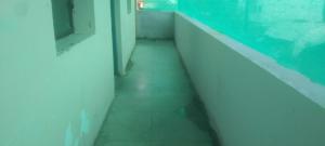 a hallway of an aquarium with a floor and a window at Hotel O Chandrapur Gadchandur formerly Hotel Relax in Chāndur