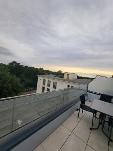 Un balcón con una mesa y sillas en un edificio. en Prora Deluxe, en Binz