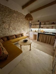 a living room with a couch and a table at Cozy 1BR Bungalow with Kitchen in Eco Garden Nature Escape in Agadir