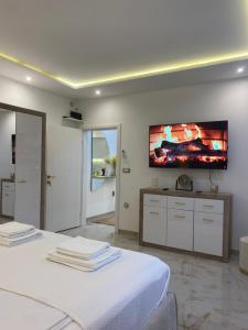 a bedroom with two beds and a flat screen tv on the wall at Beige Harmony in Smederevo