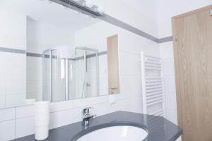 a bathroom with a sink and a mirror at Residence Mariagrazia - Kärnten Card im Sommer inklusive in Bad Kleinkirchheim