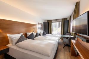 Μια τηλεόραση ή/και κέντρο ψυχαγωγίας στο AlpenParks Hotel & Apartment Taxacher