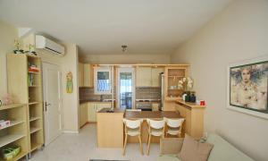 a kitchen with a table and chairs in a room at Summer House Nea Peramos in Néa Péramos +17 photos