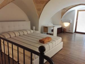 ナルドにあるAppartamento Regina Elenaのベッドルーム1室(オレンジ色の枕が付いたベッド1台付)