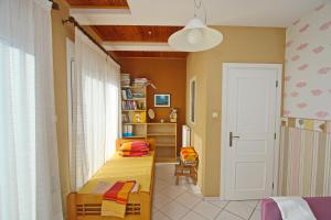 a bedroom with two beds and a book shelf at Summer House Nea Peramos in Néa Péramos