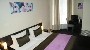 Voodi või voodid majutusasutuse Hotel Pension Eberty toas