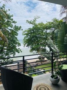 a balcony with a view of the ocean at Bloom Beach Villa in Batigama +29 photos